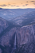 Dusk falls over Yosemite Falls in Yosemite National Park, UNESCO World Heritage Site, California, United States of America, North America