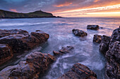 Sunset over Cape Cornwall from the rocky shores of Porth Ledden, Cornwall, England, United Kingdom, Europe