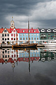 Seafront building and reflections in the water of the harbour of Torshavn, Streymoy island, Faroe Islands, Denmark, Europe