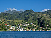 A view from the sea of the lush mountains surrounding the capital city of Roseau, on the west coast of Dominica, Windward Islands, West Indies, Caribbean, Central America
