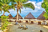 Beach umbrellas and deck chairs by the sea at Nosy Be island, Nosy Komba, North West Madagascar, Indian Ocean, Africa