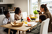 Mothers and sons eating breakfast