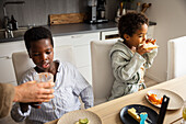 Mother and sons eating breakfast