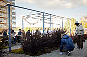 Neighbors relaxing and cleaning in communal outdoor area