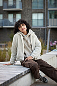 Portrait of teenage girl sitting outdoors