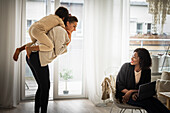 Woman giving son piggyback ride