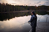 Woman fishing in lake