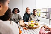 Family sitting at table on balcony