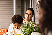 Mother and son sitting at table outdoors