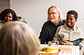 Family sitting at table outdoors