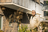 Portrait of senior man standing in residential area