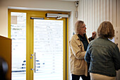 Couple entering block of flats