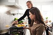 Family preparing meal in kitchen