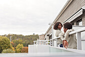 Mother and son standing on balcony