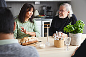 Family sitting at table and having conversation