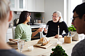 Family sitting at table and having drinks