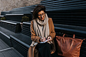 Businesswoman sitting on bench