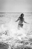 Girl running into sea