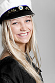 Portrait of young woman wearing captains hat