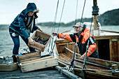 People unloading boat