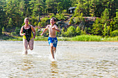 Mother running with son in lake