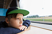 Boy in train looking through window