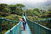 Mother with daughters on hanging bridge