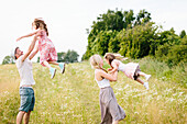 Family playing in meadow