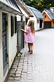 Small girl walking in pink dress