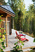 Sun chairs in front of wooden cabin