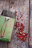 Cranberries with container on wooden background