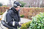 Gardener using smartphone