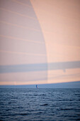 Sailing boat on sea at sunset