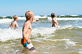 Boys swimming in sea