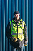 Worker standing next to container