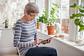 Senior woman using digital tablet