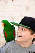 Smiling boy with parrot
