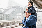 Father with son on train station platform