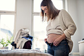 Pregnant woman getting dressed