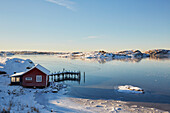 Winter landscape with lake and boat house