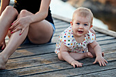 Portrait of baby girl sitting on pier