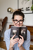 Happy young woman with book