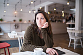 Thoughtful woman in cafe