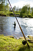 Fishing rod by river