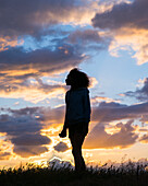 Silhouette of woman at sunset