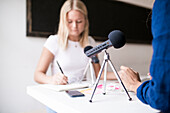 Women in office using microphones