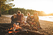 Family having campfire on beach
