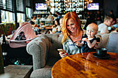 Mother with baby girl in cafe