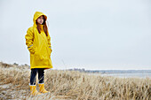 Girl in yellow raincoat looking away