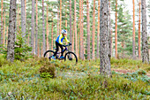 Boy riding bike in forest
